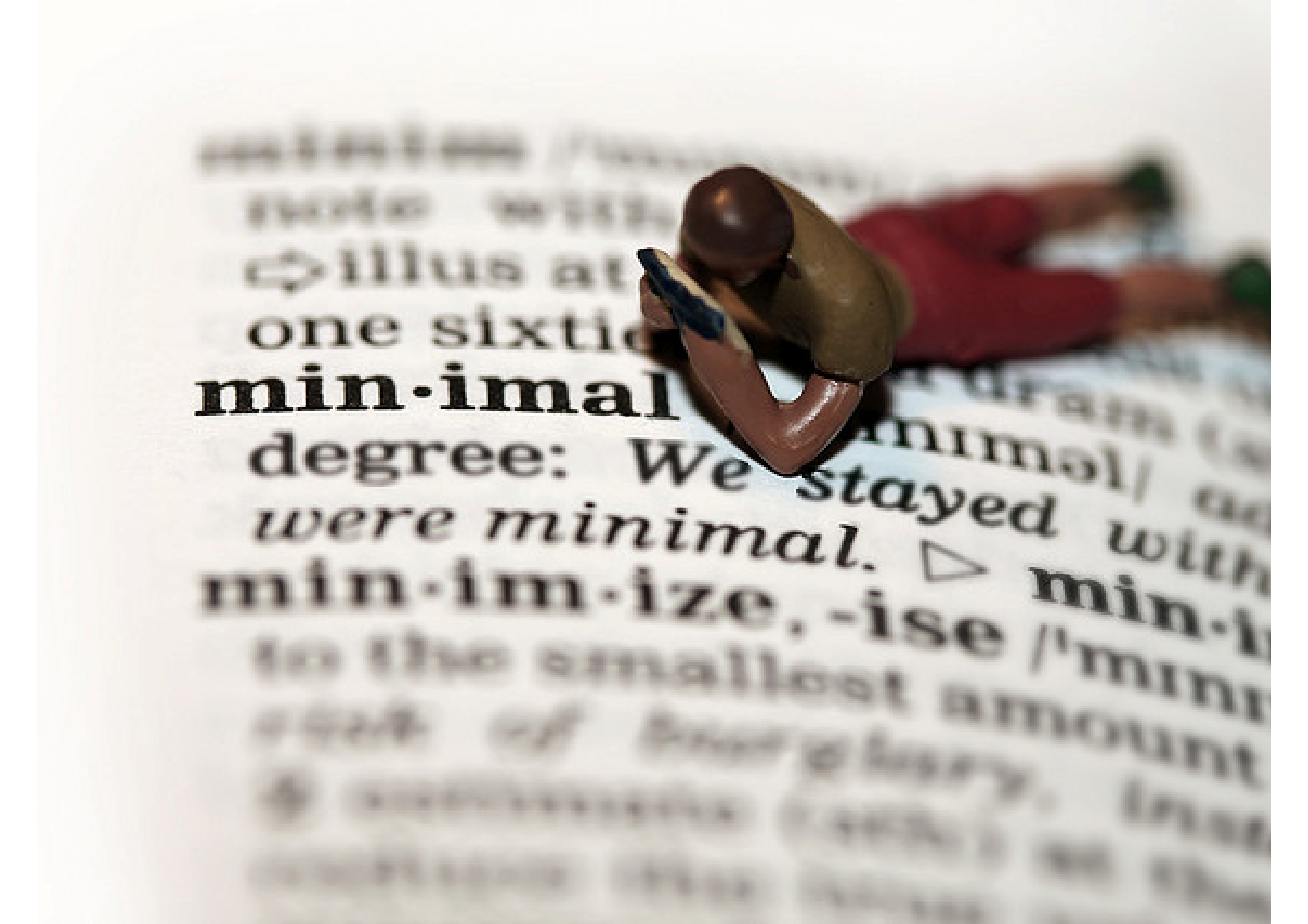 CC-licensed image by Flickr user <a href='http://www.flickr.com/photos/hebe/2217288128'>hebedesign</a>. Macro photo of tiny figure reading words in a dictionary.